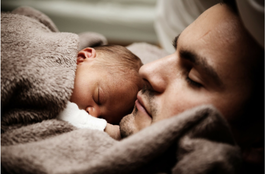 father and son covered in blanket